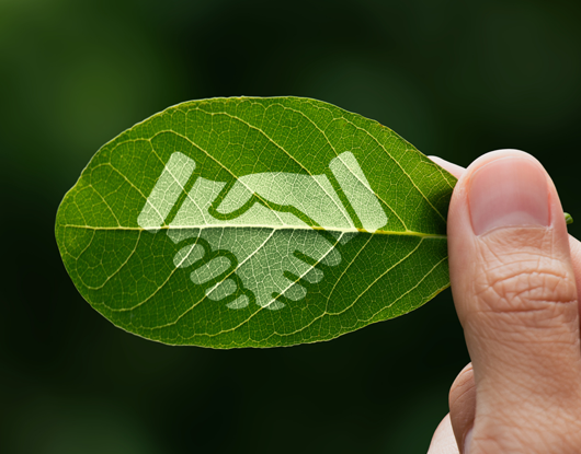 Grafik eines Händedrucks auf einem Baumblatt